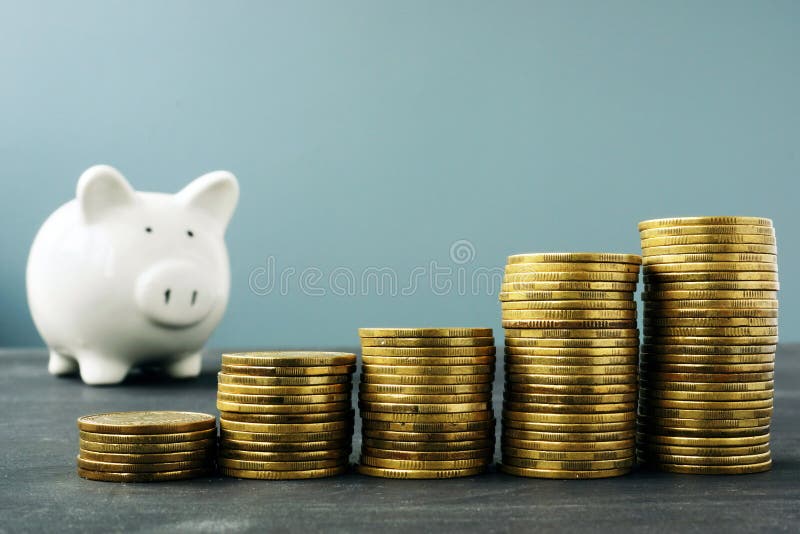 Coin stacks and piggy bank. Wealth growth and retirement plan