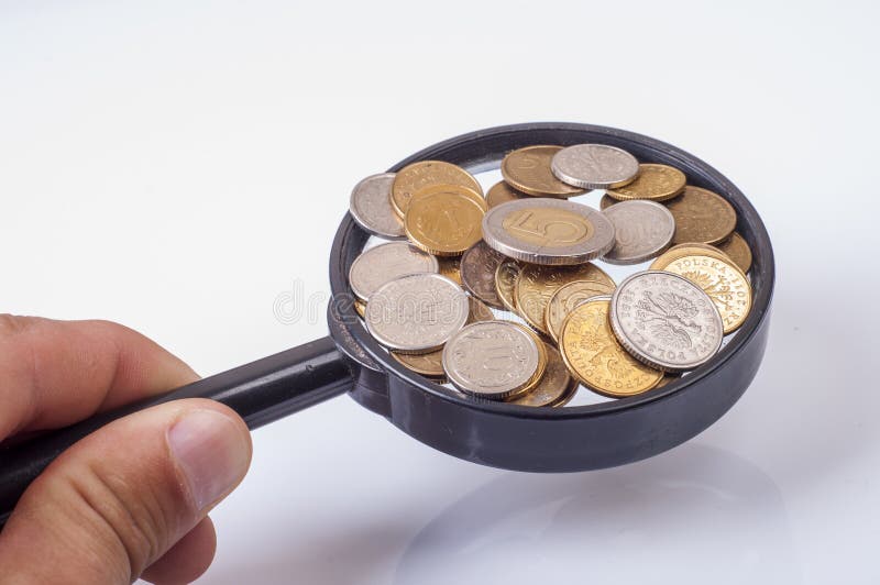 Coins on magnifying glass