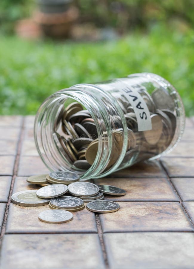 Coins Spilling Out Of A Glass Bottle Stock Photo Image of child
