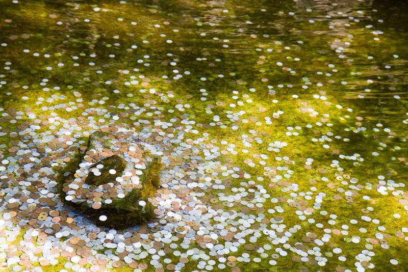 Coins in a wishing well in Kyoto