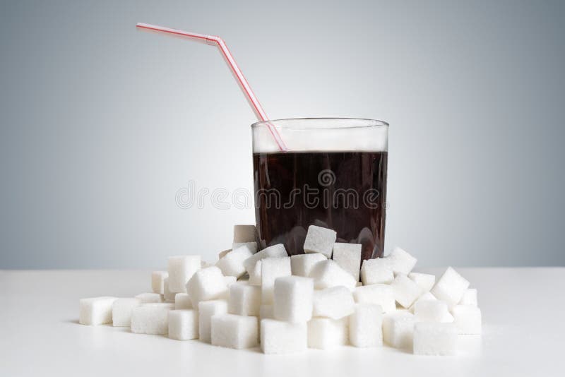Cola im Glas und viele zuckern Würfel herum Ungesundes Essenkonzept lizenzfreie stockfotos Cola im Glas und viele zuckern Würfel herum Ungesundes Essenkonzept lizenzfreie stockfotos