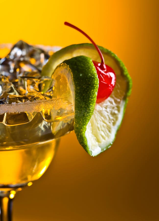 Alcoholic cocktail with cherry and lime. Cold alcoholic cocktail with ice . Cocktail garnished with cherry and lime royalty free stock image Alcoholic cocktail with cherry and lime. Cold alcoholic cocktail with ice . Cocktail garnished with cherry and lime royalty free stock image
