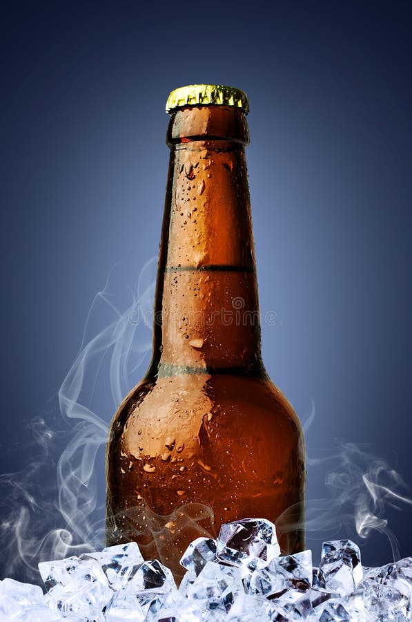 A Cold Beer in a Brown Bottle with Ice Cubes Stock Photo Image of