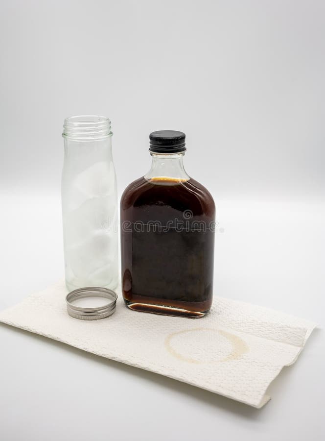 Cold Brew Coffee In Glass Bottle With Black Cap And Cube Ice In