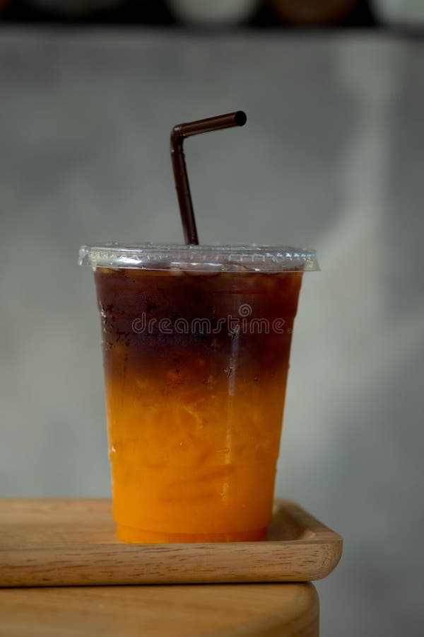 Cold Brew Coffee Mixed with Fresh Orange Juice in Plastic Glass Stock
