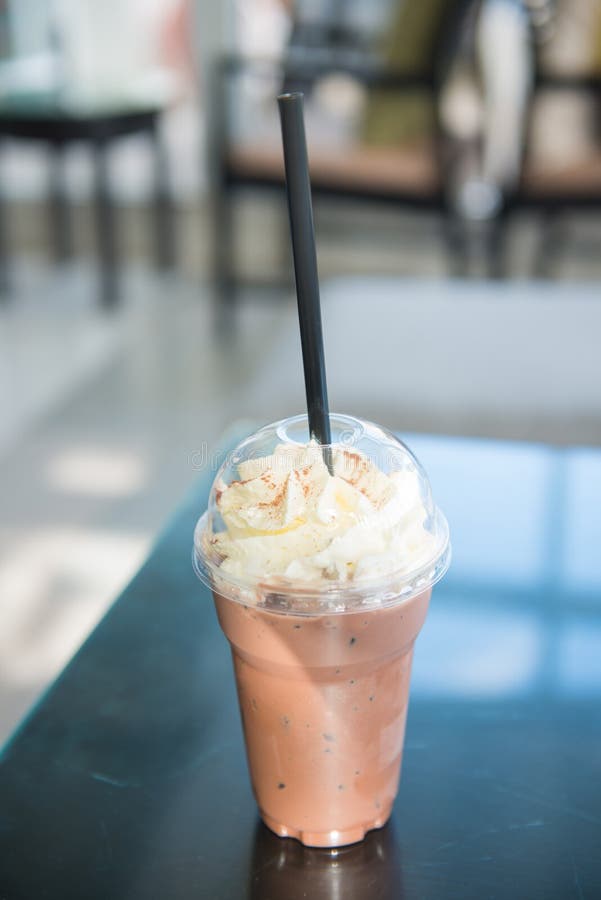 Cold Chocolate Milk with Whipped Cream in Plastic Glass Stock Photo