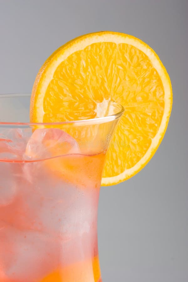 Cold Cocktail with Lemon and Champagne in Tall Glass on Backdrop of the