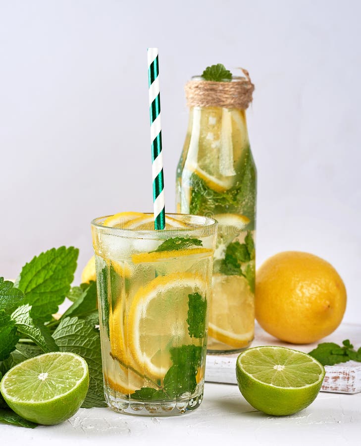 Cold Drink of Fresh Lemons, Lime, Mint Green and Pieces of Ice in a ...