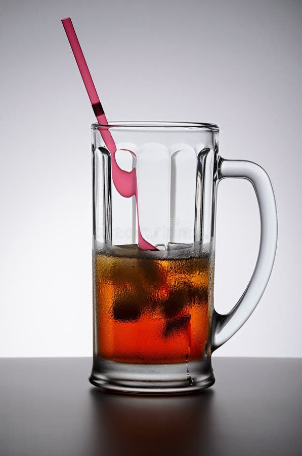 Cold Drink with Ice and Lemon in a Glass Cup with a Drinking Tube Stock