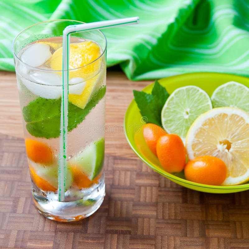 Cold Fresh Drink with Lemon, Lime, Kumquat and Mint. Stock Photo