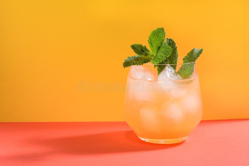 Cold Orange Drink with Ice Cubes, Mint and Bubbles Stock Photo Image
