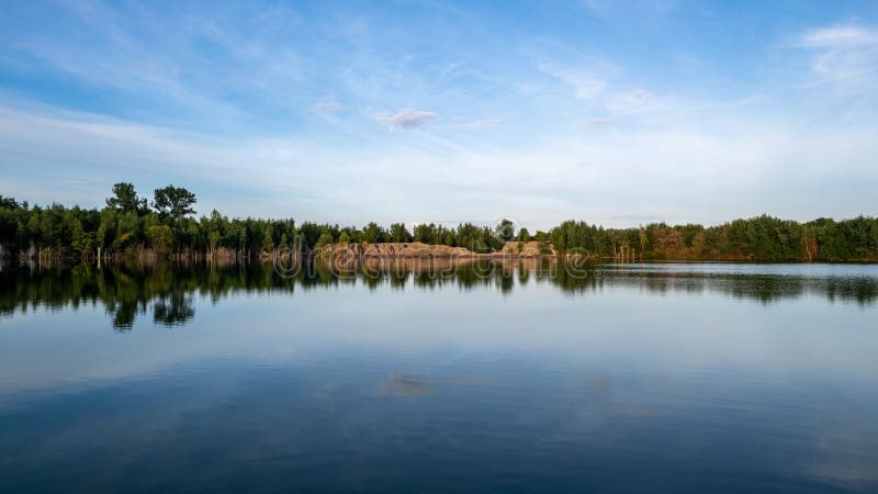 Cold Summer Morning In The Forest With Lake Forest Reflection And