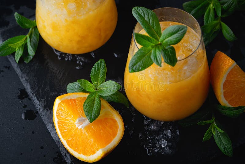 Cold Summer Orange Lemonade with Mint and Ice in a Glass Stock Photo