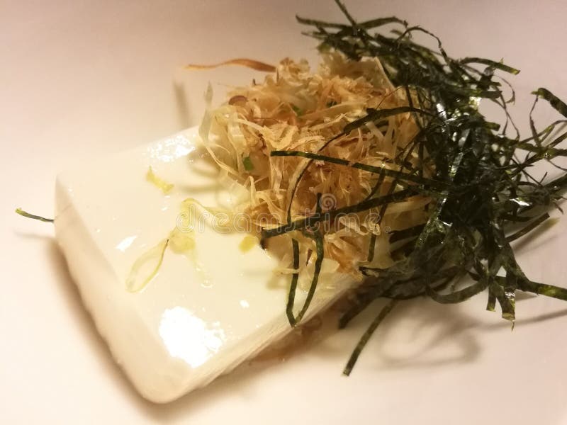 Cold tofu with seaweed and dry fish in a local restaurant, traditional Japanese food, appetizer dish, closed up royalty free stock photo Cold tofu with seaweed and dry fish in a local restaurant, traditional Japanese food, appetizer dish, closed up royalty free stock photo