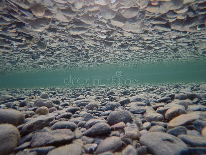 Cold Underwater River Bed with Perfect Reflection on Surface Tension