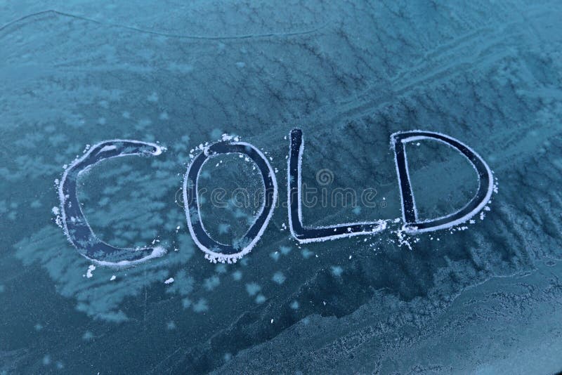 Cold written on frozen car window. Cold message written on frozen car windshield window