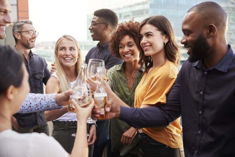 Colegas criativos do negócio que aumentam vidros e que fazem um brinde com bebidas após o trabalho fotografia de stock Colegas criativos do negócio que aumentam vidros e que fazem um brinde com bebidas após o trabalho fotografia de stock