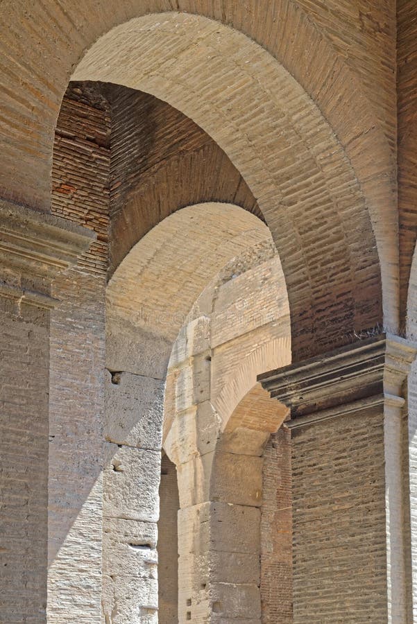 Image taken of detail of ancient Roman coliseum arch made of stone.