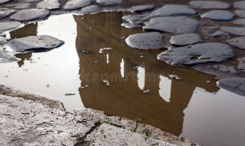 Coliseum reflection in a puddle after the rain - Rome, Italy. Coliseum reflection in a puddle after the rain - Rome, Italy.