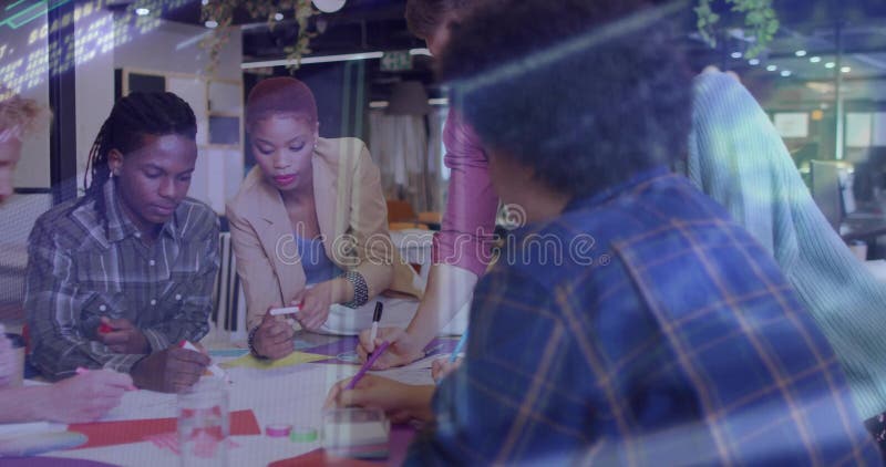 Collaborating six colleagues sketching ideas around open-plan office table using colored markers royalty free stock photos