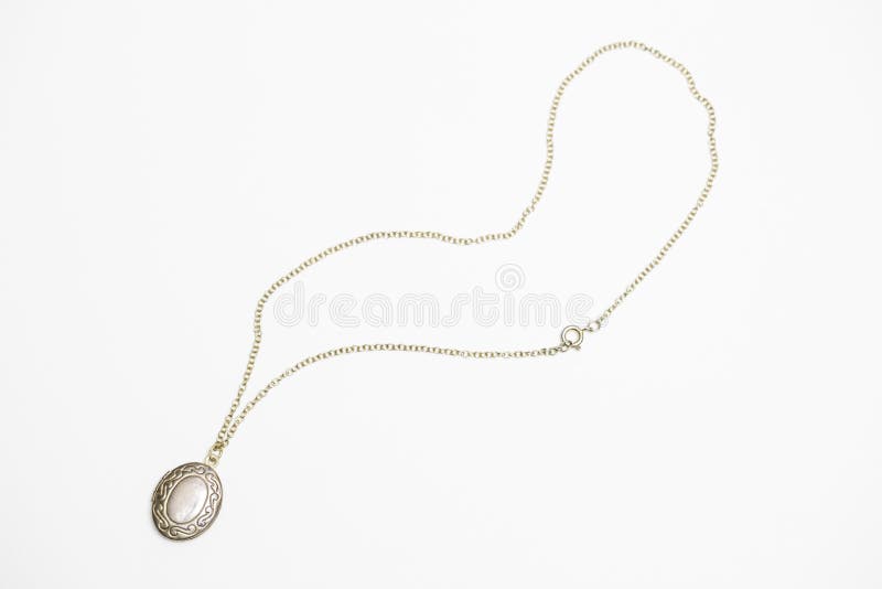 Gold pendant locket necklace on a white background shot up close. Gold pendant locket necklace on a white background shot up close