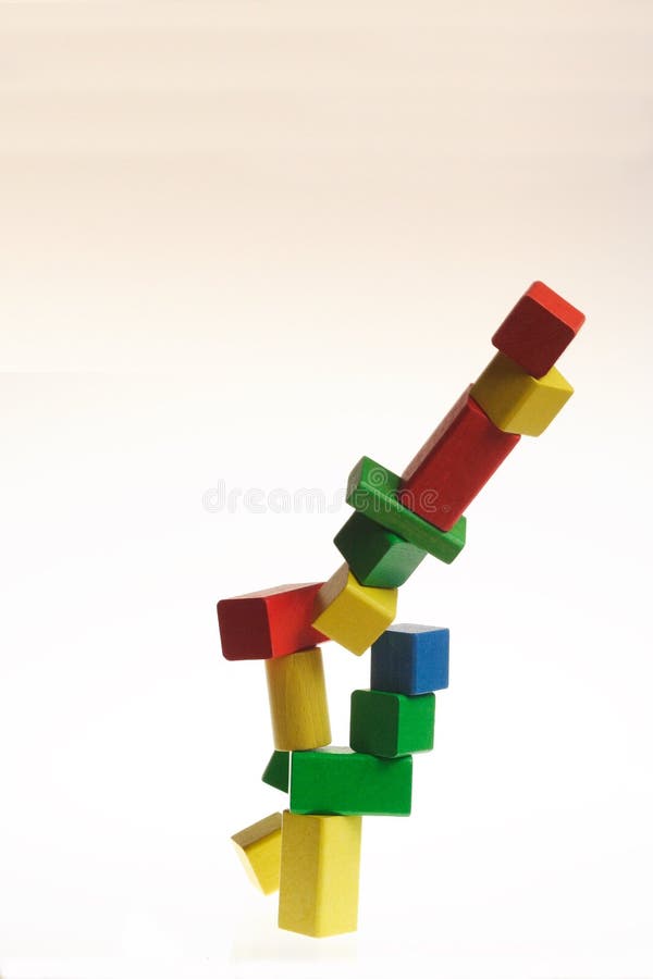 Collapsing set of colorful wooden blocks royalty free stock photography