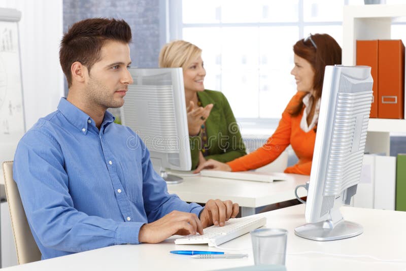 Colleagues working in office stock images