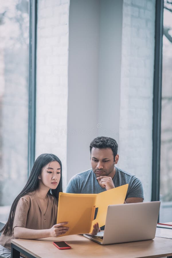 Colleagues working in the office and looking concentrated royalty free stock photography