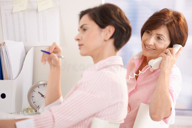 Colleagues working together in office stock photography