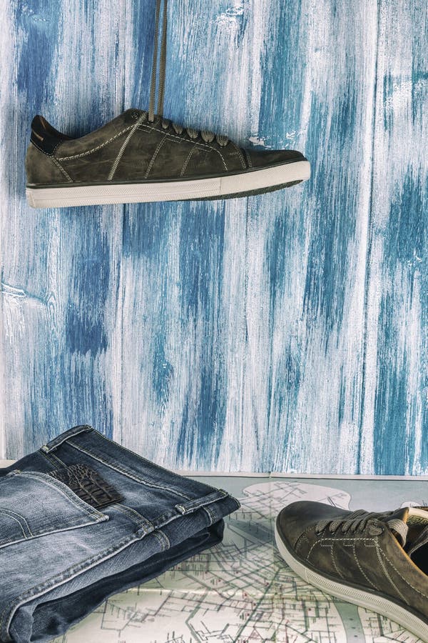 Collecting to travel. Jeans, passport, sneakers and a map on a wooden background. Summer travel. stock image Collecting to travel. Jeans, passport, sneakers and a map on a wooden background. Summer travel. stock image