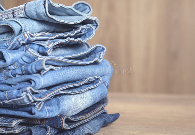 Collection of Blue Jeans on Table Stock Image - Image of design ...