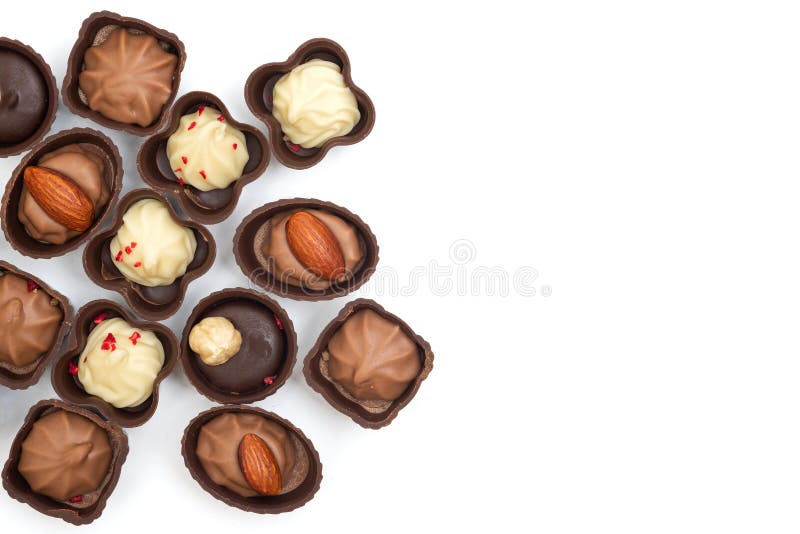 Collection of chocolates, top view. Various chocolate pralines isolated on white background