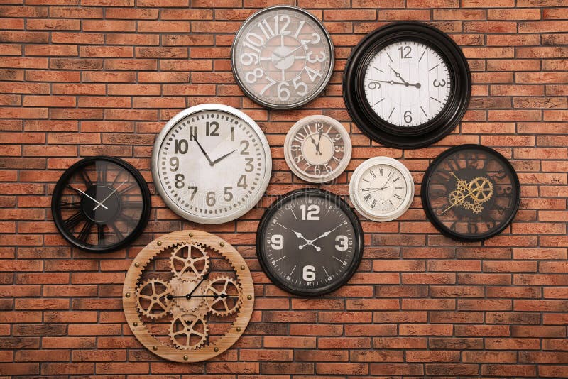 Collection of Clocks Hanging on Red Brick Wall Stock Image Image of