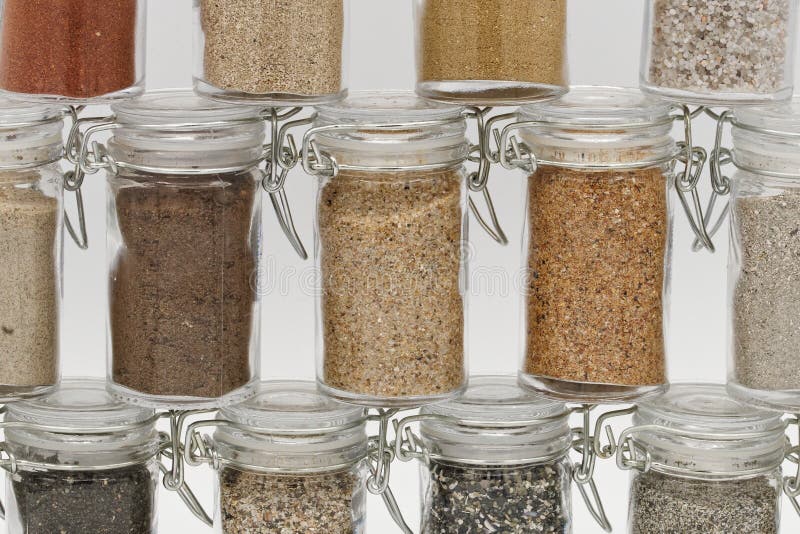 Collection of different types of sand in glasses