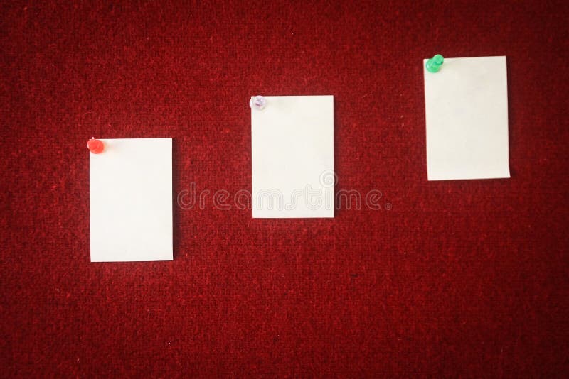 Collection of note papers pinned on a red board ready for filling in quotes.