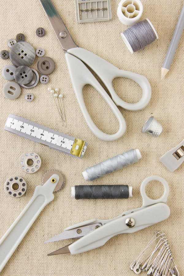 Needlecraft and sewing tools. A collection of sewing, needlecraft, dressmaking, tailoring tools and items in harmonising neutral greys and beige royalty free stock photos Needlecraft and sewing tools. A collection of sewing, needlecraft, dressmaking, tailoring tools and items in harmonising neutral greys and beige royalty free stock photos