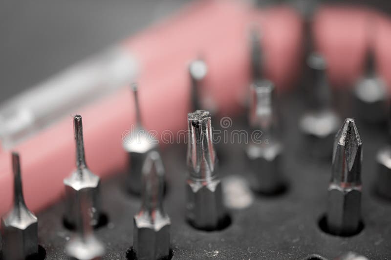 Collection of various screwdriver bits arranged on a tool organizer in a workshop setting during the day stock photography