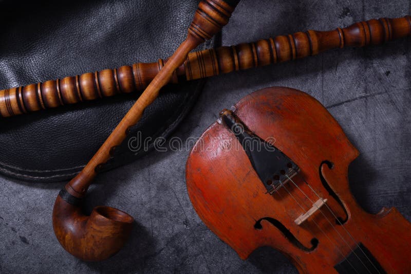 A collection of vintage musical instruments rests on a dark surface stock photo