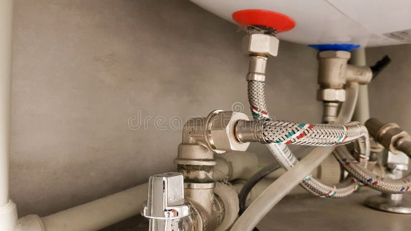 Connection of water supply, hot and cold water to the boiler. Hose for hot and cold water in the bathroom. Plumbing connections for a domestic electric water heater. Connection of water supply, hot and cold water to the boiler. Hose for hot and cold water in the bathroom. Plumbing connections for a domestic electric water heater