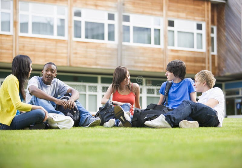 College students sitting and talking on lawn stock photos College students sitting and talking on lawn stock photos