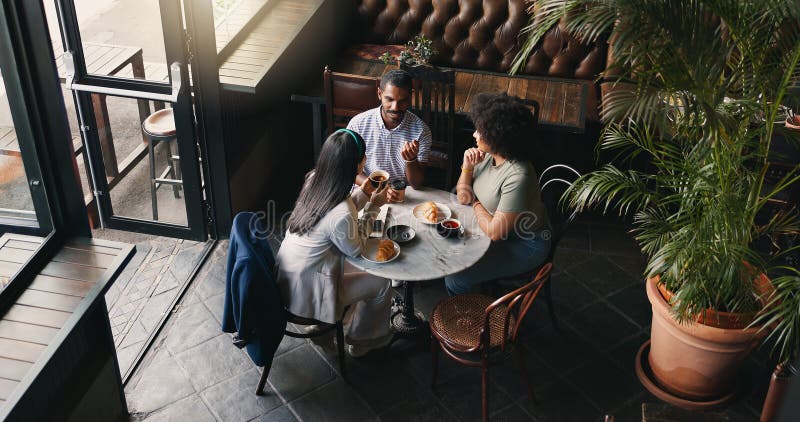 Group, colleagues and talking in coffee shop or brainstorming startup idea, planning or collaboration. Man, women and diversity teamwork with notebook or creative company vision, lunch or discussion. Group, colleagues and talking in coffee shop or brainstorming startup idea, planning or collaboration. Man, women and diversity teamwork with notebook or creative company vision, lunch or discussion.