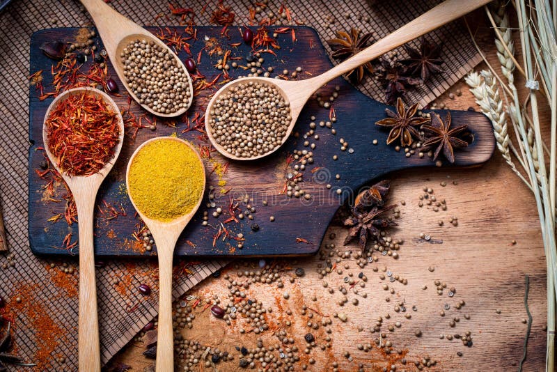Coloful Various Spice and Herbs in Wood Spoon on Natural Texture Stock
