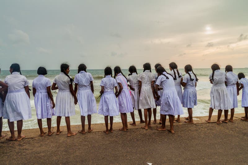 COLOMBO, SRI LANKA - JULY 26, 2016: Girls in school uniforms watch a sea in...