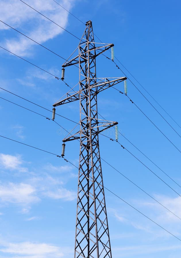 Electric pillar on the background of the cloudy sky. Electric pillar on the background of the cloudy sky