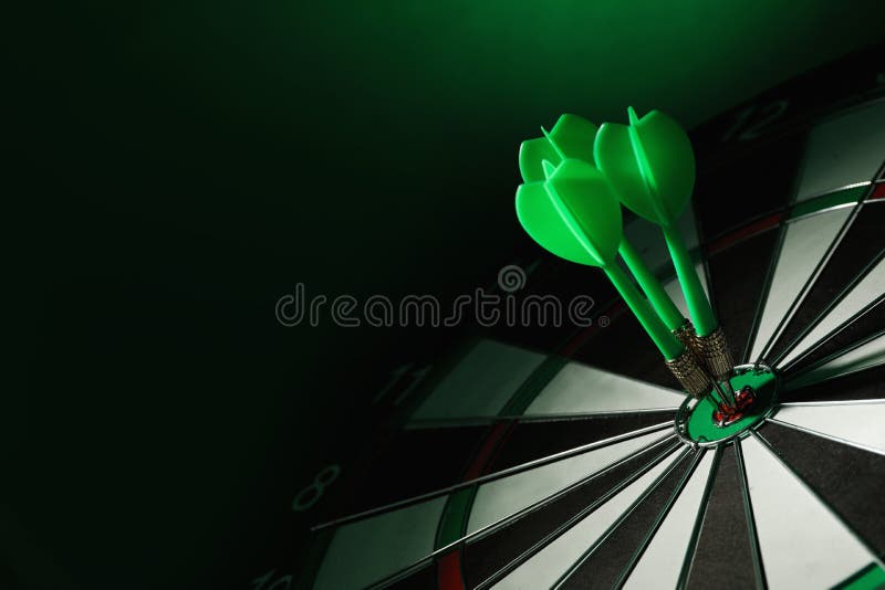 Color arrows hitting target on dart board against green background