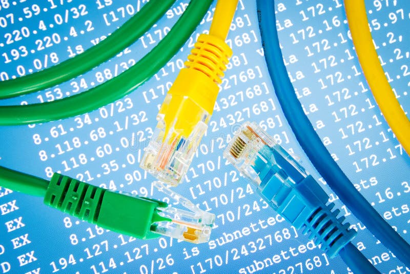 Color Ethernet cables with routing table on the blue background stock photos