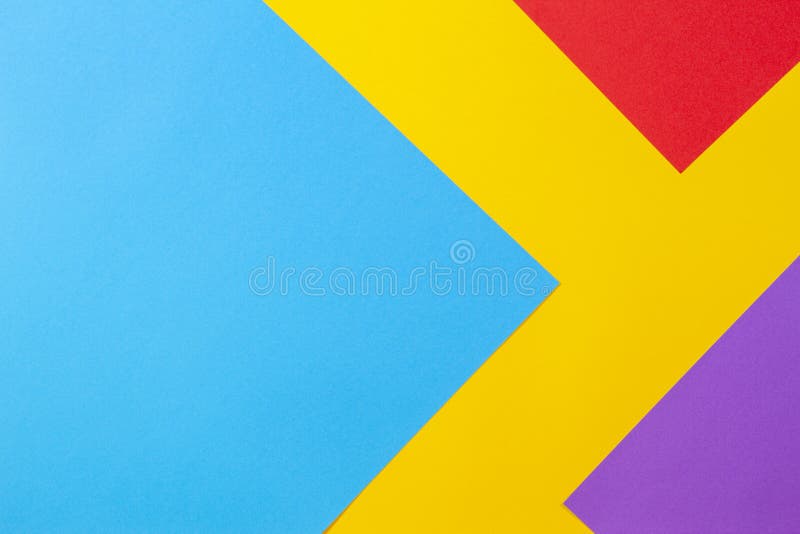 Color papers geometry flat composition background with yellow red blue and purple tones stock photo