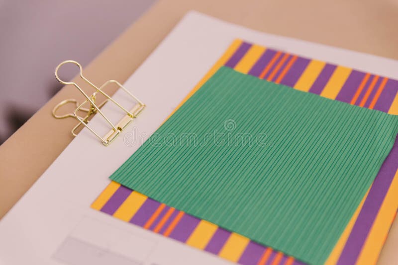 Color Papers and Golden Clip Over The Wooden Table royalty free stock photos