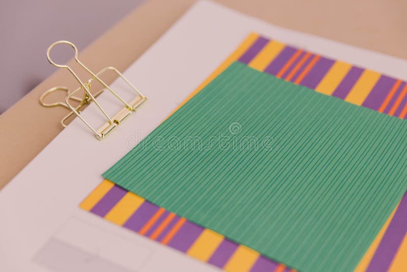 Color Papers and Golden Clip Over The Wooden Table royalty free stock images