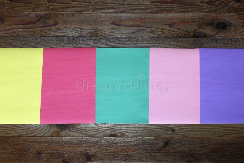 Color papers and wood background stock photo